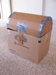 an amazon box sitting on the floor with duct tape wrapped around it's sides