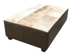 a brown ottoman sitting on top of a white floor