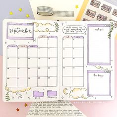 an open planner book sitting on top of a pink and white desk with stars, clouds and