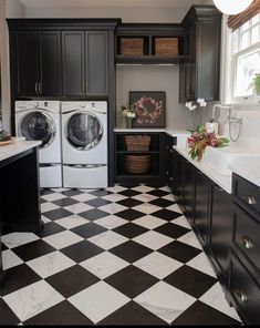 a black and white checkered floor in a laundry room with washer and dryer