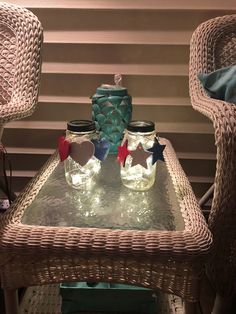 two mason jars sitting on top of a glass table