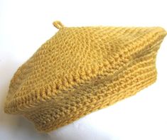 a yellow knitted hat sitting on top of a white mannequin head