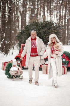 a man and woman are walking through the snow