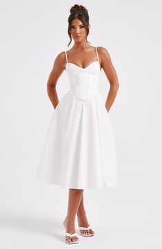 Make an entrance in Mariella, the party midi of your dreams this season. Super feminine and chic, this ivory dress is truly an icon with a structured, corseted bodice that's boned to cinch your waist and contrasted by a full, voluminous skirt.