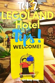 a person holding up a yellow sign that says top 7 legoland hotel this is welcome