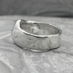 The liquid Ring Processing Type: Volcanic oxidation+Polishing Width 6-7 mm Weight about 8-9g (depends on size) Description: The wide band of silver resembles liquid metal. The glossy texture becomes matte over time and acquires a unique texture that reflects the character of its owner. It is ideal for daily wear. This ring can be a great choice for engagement rings if you want something minimal and stylish. My wife and I chose just such a texture for our wedding rings, and it is interesting for Wax Carved Ring, Mens Silver Bangle, Silversmithing Jewelry, Product Card, Unique Silver Rings, Liquid Metal, Jewelry Accessories Ideas, Sterling Silver Rings Bands, Textured Ring