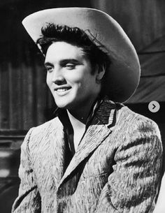 a man wearing a cowboy hat sitting down