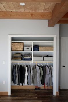 an organized closet with clothes and shoes