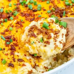 a wooden spoon scooping out some mashed potatoes from a casserole dish