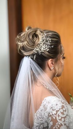 a woman in a wedding dress with a veil on her head