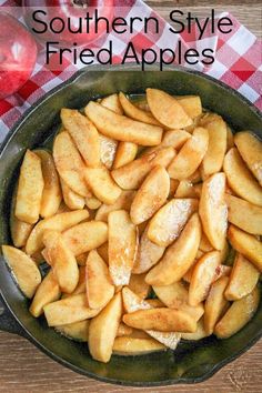 a frying pan filled with fried apples on top of a table