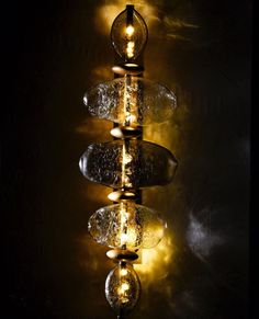 a chandelier with lights hanging from it's sides in a dark room