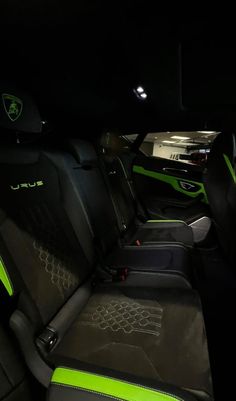 the interior of a car with neon green and black leather trims, including two seats