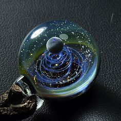 "After purchase, send the phone number to me because the post office needs it so that it can be reached faster Its materials: opal, glass, gold and silver Glass pendant measures approximately 0.86-0.95\" (2.2-2.4 cm) in diameter. 1.2\"(3 cm) in height The glass pendant comes with a brown cord . (Adjustable the length of black cord via he wooden bead.) This charming necklace will arrive at your home securely nestled come in a lighting gift box and tucked in a safe package :) If your purchase is a Space-themed Pendant Jewelry Gift, Space-themed Pendant Necklace As Gift, Universe Necklace, Galaxy Necklace, Galaxy Pendant, Lighting Gifts, Unique Birthday Gift, Small Gift Bags, Glass Artwork