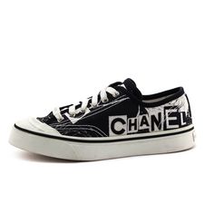 These Chanel Low Top Sneakers present an edgy, yet effortlessly cool design that will grant you comfort on your busiest days. Made in Spain, these luxury sneakers feature a black and white printed canvas exterior. A large embroidered Chanel logo adorns the side of each designer shoe and a printed camellia flower design adorns each vamp. A black rubber trim surrounds the white rubber soles and an embossed logo embellishes the back of each rubber heel. The front white fabric lace-up closure is accompanied by a small silver-toned logo embossed plaque. Wear these Chanel Canvas Sneakers with a black trench coat, your favorite t-shirt, jeans, and the Prada Black Nylon & Leather Gaufre Satchel to make an impact. Canvas High-top Sneakers With Logo Print For Streetwear, Designer Black High-top Sneakers With Logo Print, Streetwear Canvas Lace-up Shoes With Embroidered Logo, Streetwear Canvas Shoes With Embroidered Logo, White Canvas Sneakers With Logo Print, Casual Custom Sneakers With Embroidered Logo And White Sole, Black Embroidered Logo Lace-up Sneakers, Black Lace-up Sneakers With Embroidered Logo, Sporty Low-top Canvas Shoes With Embroidered Logo