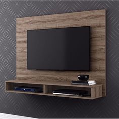 a flat screen tv mounted to the side of a wooden entertainment center in a living room