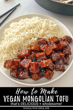 the plate has rice and meat on it with chopsticks in front of it