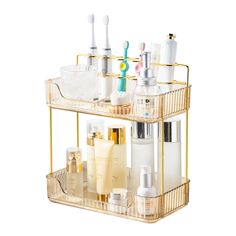 a gold metal shelf with toothbrushes, lotion and other items on it