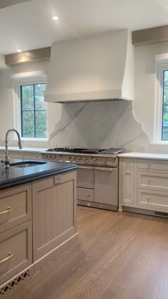 a kitchen with an oven, stove and sink in the middle of it's counter tops