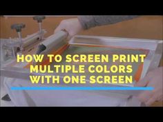 a person using a screen printing machine to print multiple colors with one screen on the printer