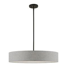 a light fixture with a drum shade hanging from it's center point, on a white background