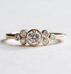 a gold ring with three diamonds on it