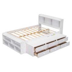 a white bed with drawers underneath it