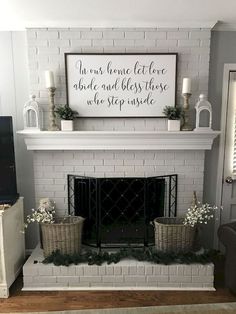 a white brick fireplace with some baskets on the mantel and a sign above it