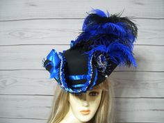 "Black and royal blue pirate hat with black and silver trim, royal blue pleated satin trim, black and royal blue ostrich feathers, royal blue satin bows, black cocarde with a royal blue jewel center. This hat is about 22 1/2\" for the inside circumference. If this is too big for you then let me know and I can include a hat sizer in your package. I cannot make the circumference of this hat larger so please measure your head as all sales are final. Please keep that in mind when purchasing. I ship Adjustable Blue Costume Accessories For Costume Party, Blue Costume Hat For Carnival, Adjustable Blue Costume Hats And Headpieces, Blue Adjustable Costume Hats For Carnival, Adjustable Blue Costume Hats For Carnival, Blue Costume Hats And Headpieces For Carnival, Black Hats For Mardi Gras Costume Party, Blue Halloween Costume Hats And Headpieces, Black Pirate Hat For Party