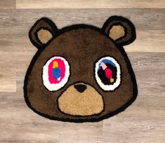 a brown teddy bear rug with big eyes on top of wood flooring in a room