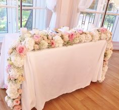 the table is covered with pink and white flowers