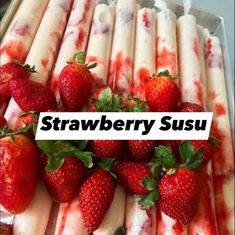 strawberries and ice cream are arranged in a tray