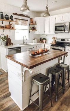 a kitchen island with two stools next to it and an oven in the background