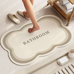 a woman standing on the bathroom floor with her feet up