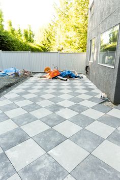 an outdoor patio with grey and white tiles