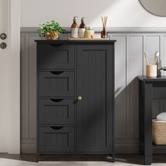 Consolidate your space with this freestanding bathroom cabinet, and add a hint of breezy charm to any open corner. Crafted from engineered wood in a muted tone, it has a side door and four drawers for towels and bathroom essentials. All fronts feature picture-frame paneling and vertical shiplap planks for that coastal vibe we love. The drawers also show off half-moon cutout handles for hassle-free access to your toiletries. At just under 32" tall and approximately 22" wide, this cabinet is the i Frame Paneling, Mom Bathroom, Storage Cabinet Bathroom, Moon Cutout, Vertical Shiplap, Practical Bathroom, Bathroom Floor Storage Cabinet, Bathroom Standing Cabinet, Tall Bathroom Storage