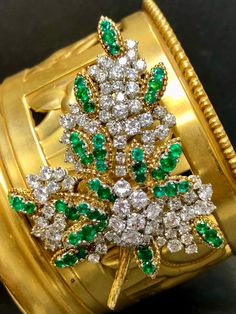 French made brooch done in 18K yellow gold and platinum circa 1960's set with approximately 8cttw in larger G-H color Vs1-2 clarity rounds diamonds as well as approximately 5cttw in vibrant green emeralds. All hallmarks and export marks are intact. Dimensions/Weight 2" wide by 2.25" long. Weighs 23dwt.  Condition Two emeralds have minor chips, but nothing obvious. May we all age as well. Luxury Green Brooch For Formal Occasions, Luxury Green Brooch For Anniversary, Luxury Green Brooches For Anniversary, Vintage Green Diamond Brooches, Green Diamond Wedding Brooches, Fine Jewelry Green Brooches For Anniversary, Fine Jewelry Green Brooch For Anniversary, Green Fine Jewelry Brooch For Anniversary, Leaf Brooch