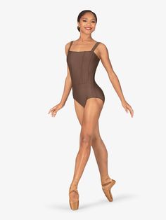 a woman in a brown leotard and ballet shoes is posing for the camera