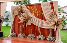 an outdoor stage decorated with flowers and grass