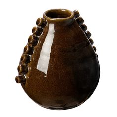 a brown and black vase sitting on top of a table