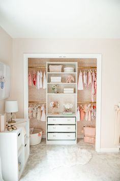 a baby's closet with clothes, toys and other items on shelves in it