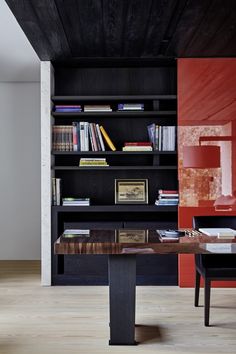 a room with bookshelves and a table in it