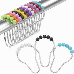 several different colored beads hang from a metal rack with two clips on each side and one is