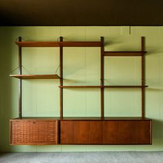 an empty room with shelving unit in it