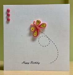 a birthday card with a paper flower on it