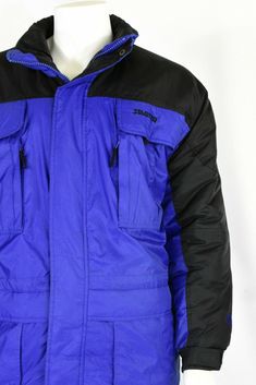 "Royal blue with contrasting black on the shoulders, sleeves, & zipper pulls. Polyfill. Elasticized cuffs. 6 outside front zip pockets. Inside waist adjuster . Great pre-owned vintage, however, the coat is missing its zip-off hood. Estimated Modern Size: XL *Vintage clothing runs significantly smaller than modern clothing. We offer a comprehensive size estimation in accordance with modern-day size charts. Vintage Tag Size: XL Material: nylon Lining: synthetic Closure: zip, velcro, & snap Weatherproof Blue Outerwear For Streetwear, Winter Blue Windbreaker With Zipper Closure, Blue Waterproof Outerwear For Streetwear, Blue Waterproof Streetwear Outerwear, Blue Windbreaker With Zipper Closure For Outdoor, Blue Windbreaker With Pockets For Cold Weather, Blue Windbreaker With Zipper For Outdoor, Blue Streetwear Outerwear With Side Pockets, Blue Long Sleeve Windbreaker For Winter Sports