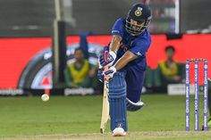 a cricket player hitting the ball with his bat