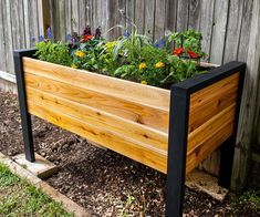 a wooden planter filled with lots of plants