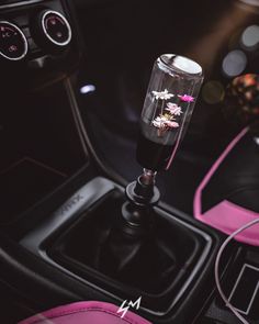 the interior of a car with pink and black accessories