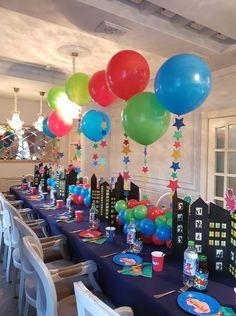 a party with balloons and decorations on the table